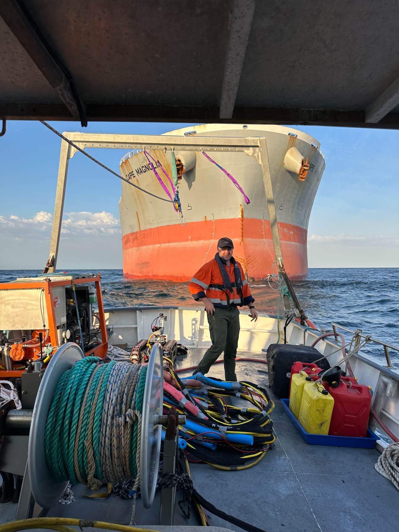 Crew member on a workboat deck at golden hour