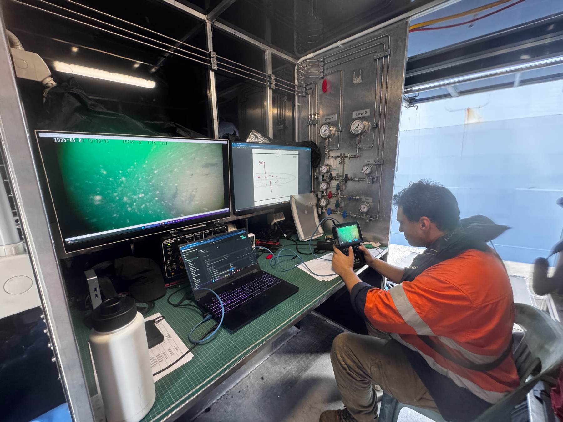 Dive supervision control room with live monitoring screens