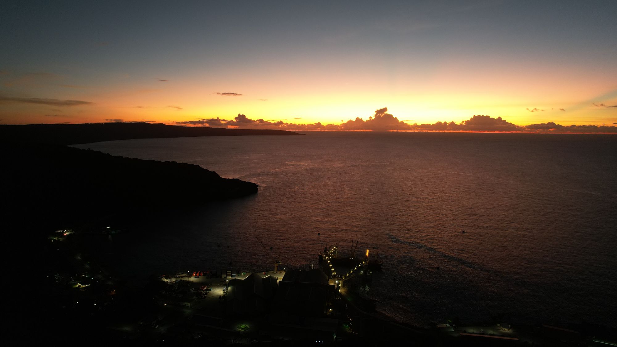 Aerial view of a port facility at dusk