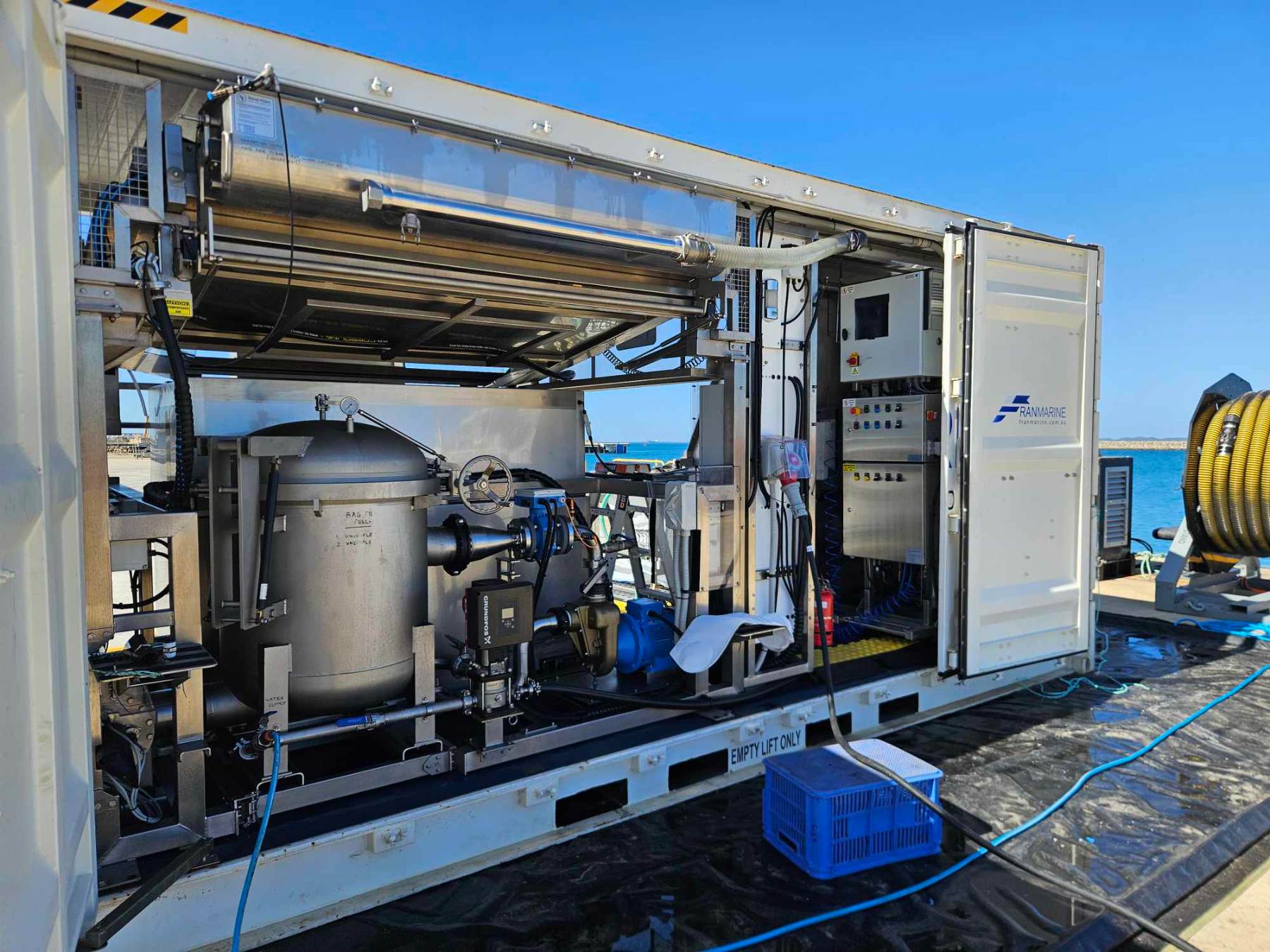 Open containerised filtration plant with stainless vessel and pumps on a wharf