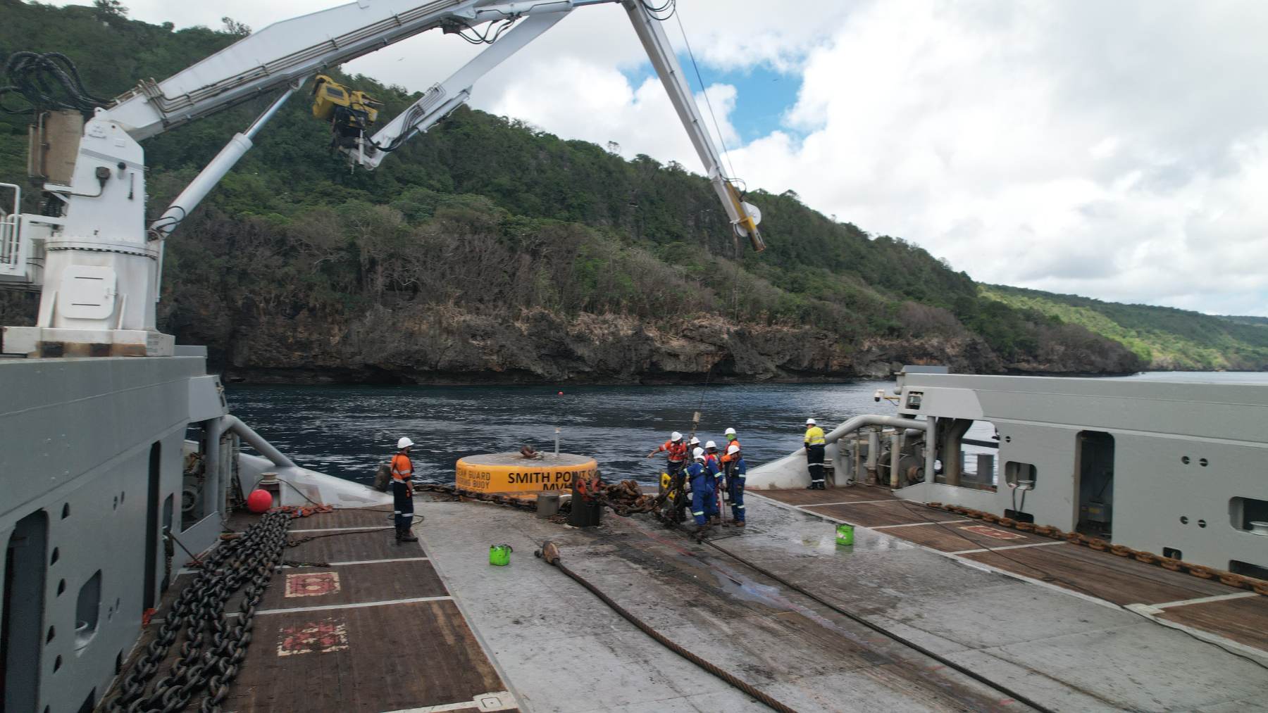 Crew working around a mooring buoy on a vessel deck