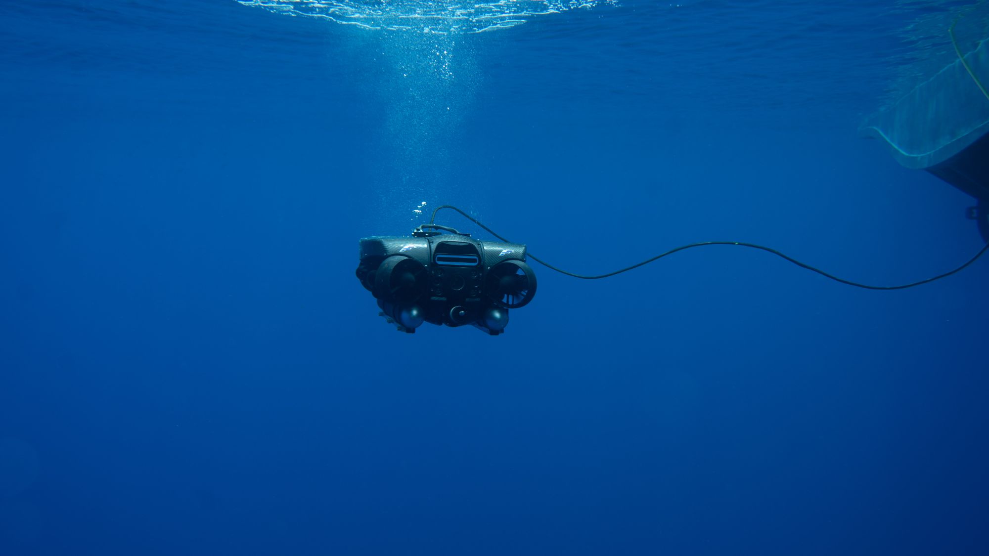 ROV suspended in deep blue open water
