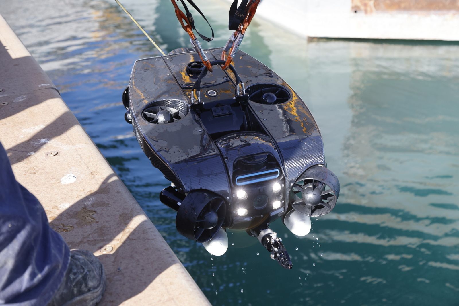 ROV lifted on slings above harbour water during recovery