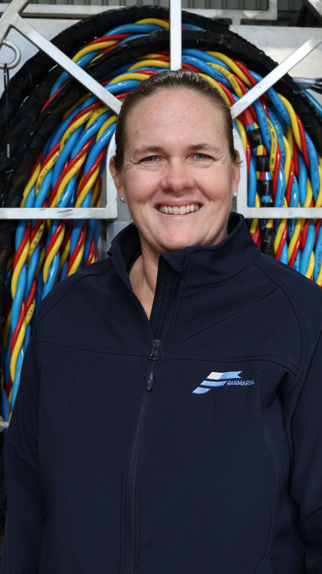Team member in front of racked dive umbilicals